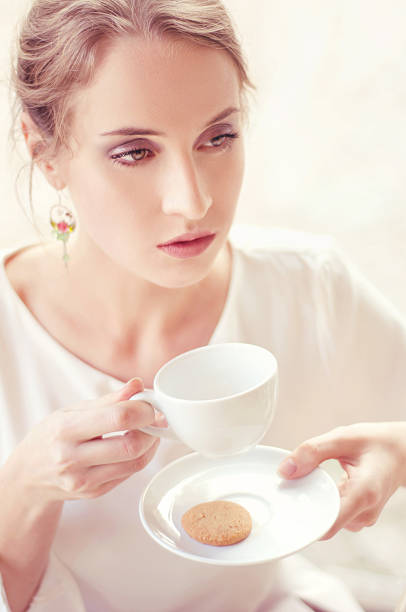 istock Beautiful elegant blonde sitting in a cafe drinking tea 470173512