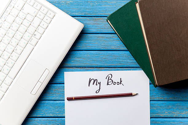 istock paper with My Book inscription near notebook 470174520
