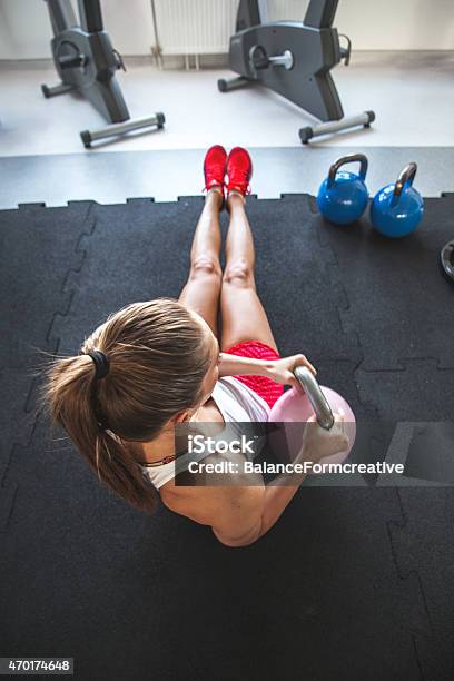 A Woman Doing A Abs Workout Using A Kettle Bell Weight Stock Photo - Download Image Now