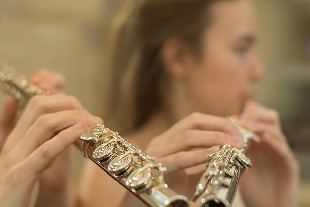 istock Fingers on flute with blurred face 470176982