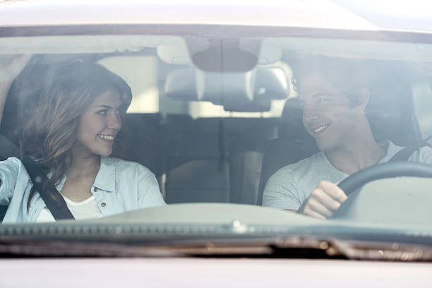 istock Couple on a road trip driving a car 470177412