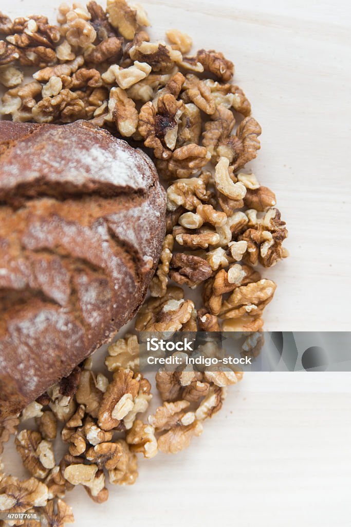 Brown Bread and Walnuts Freshly baked Brown Bread  surrounded with Walnuts, Focus on Walnut 2015 Stock Photo