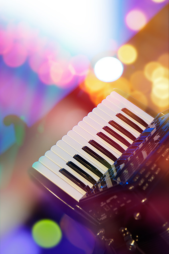 Accordion with color bokeh light in background