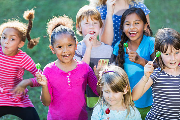 istock Group of multiracial children eating lollipops 470180560