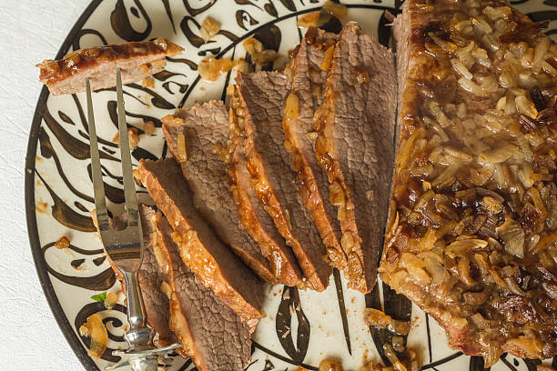 Jewish Passover Brisket Jewish Passover brisket with savory walnut breading sliced and ready to serve brisket photos stock pictures, royalty-free photos & images