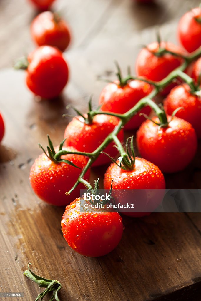 Raw Organic Red Cherry Tomatoes Raw Organic Red Cherry Tomatoes on the Vine 2015 Stock Photo