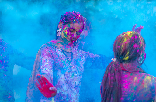 Young Indian girls celebrating the festival of color Holi, Jaipur, Rajasthan, India.