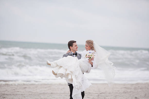 istock wedding on the beach in winter 470186212