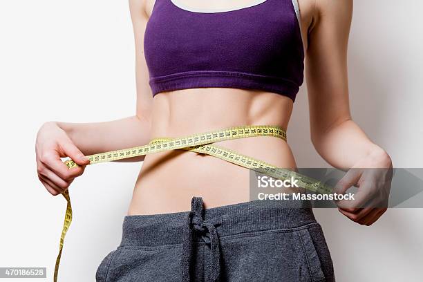 Woman Showing Her Abs With Metric Stock Photo - Download Image Now - 2015, Abdominal Muscle, Active Lifestyle