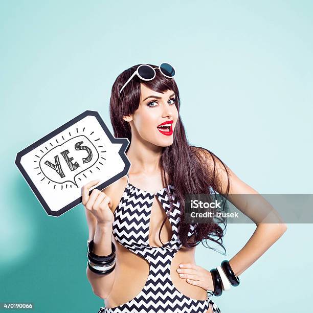 Happy Young Woman Wearing Swimsuit Holding Speech Bubble Stock Photo - Download Image Now