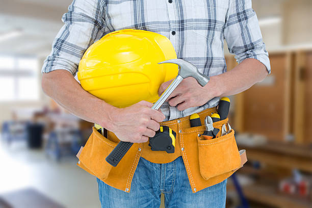 istock Composite image of technician holding hammer and hard hat 470190238