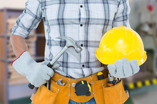 istock Composite image of handyman holding hammer and hard hat 470192982