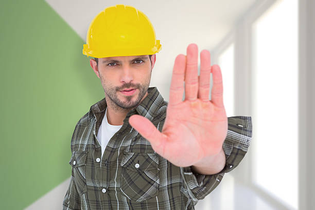 istock Composite image of confident manual worker gesturing stop sign 470193630