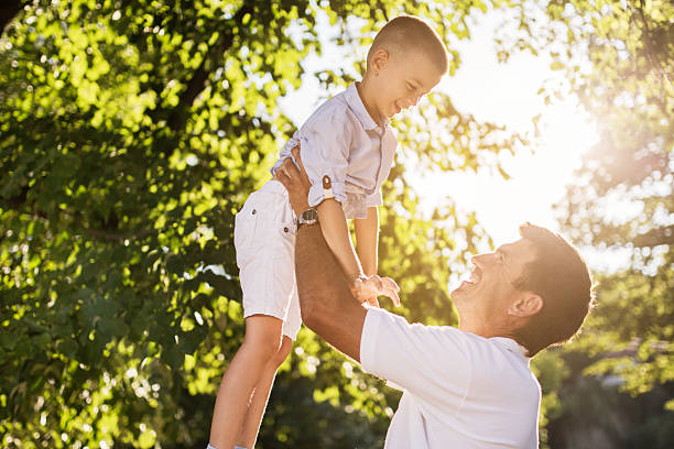 istock Playful father and son having fun in the park. 470194044