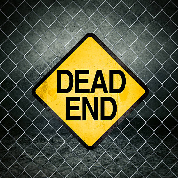 Dead End Grunge Yellow Warning Sign on Chainlink Fence Dead End Grunge Yellow Warning Sign on Chainlink Fence of Industrial Warehouse impassable limit stock pictures, royalty-free photos & images