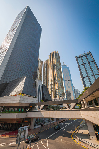 Gleaming glass and steel citadels of commerce stretching into the blue sky above the concrete highways and pedestrian walkways of Hong Kong's Central District, China. ProPhoto RGB profile for maximum color fidelity and gamut.
