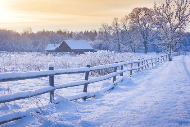 Photo of Rural house with a fence in winter
