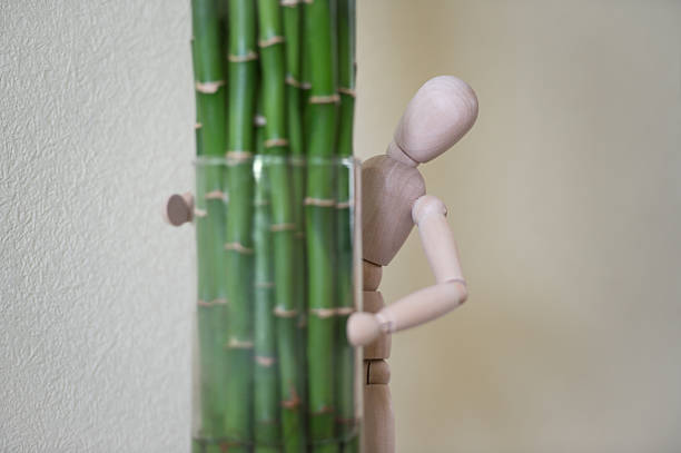 istock Wooden man looking out of the tree. 470197964