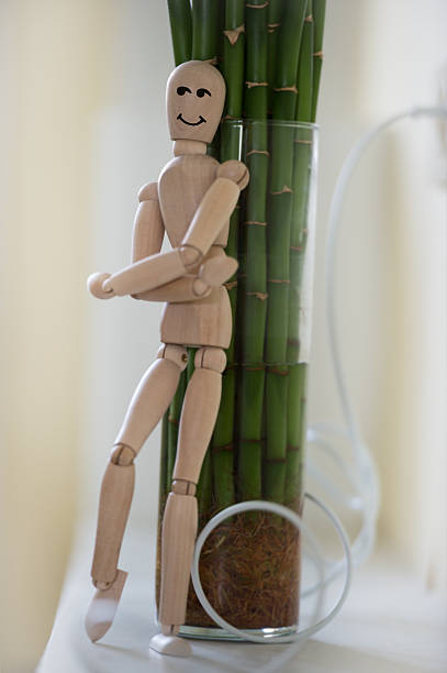 istock Wooden man looking out of the tree. 470197970