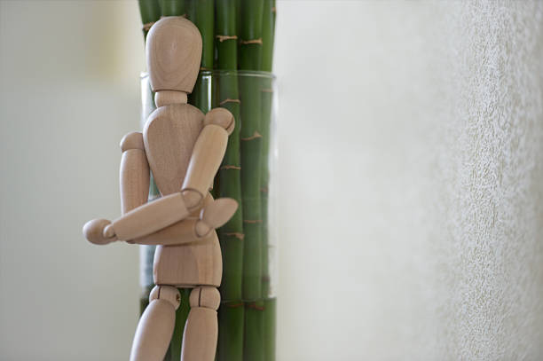 istock Wooden man looking out of the tree. 470197974