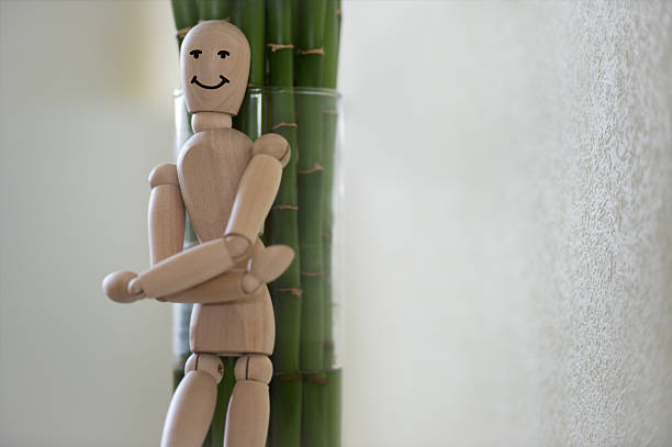 istock Wooden man looking out of the tree. 470197976