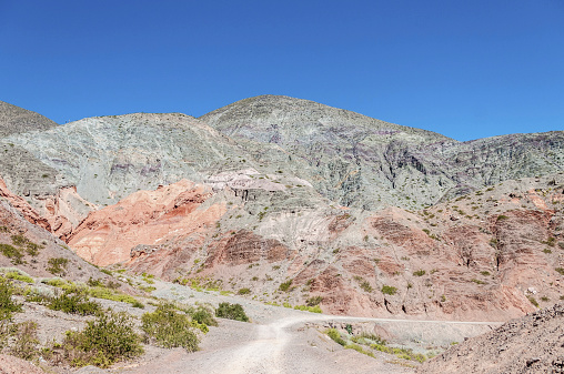 Los Colorados path in Purmamarca, near Cerro de los Siete Colores (The Hill of Seven Colors), in the colourful valley of Quebrada de Humahuaca in Jujuy Province, northern Argentina.