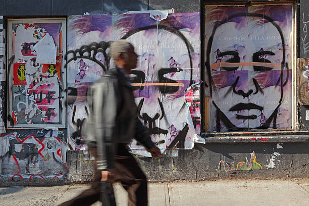 Austin, USA - March 17, 2019. A man walking by a big mural in downtown Austin, Texas, USA