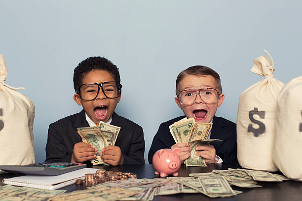 Young Business Children Make Faces Holding Lots of Money A couple of young businessmen are astounded by the profits coming in. jackpot photos stock pictures, royalty-free photos & images