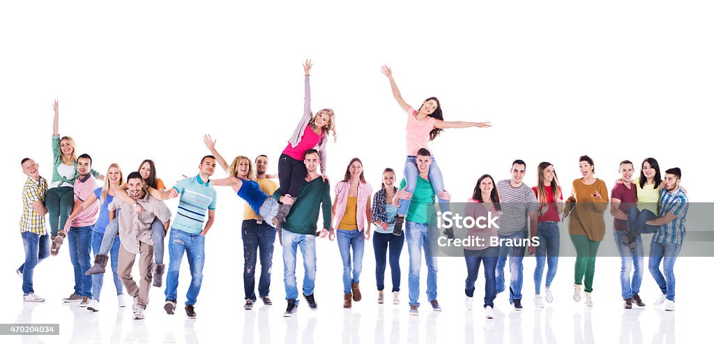 Group of playful young people isolated on white. Large group of cheerful young people having fun and looking at the camera. Isolated on white. Group Of People Stock Photo