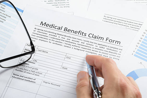 istock Hand With Pen Over Medical Claim Application 470204490