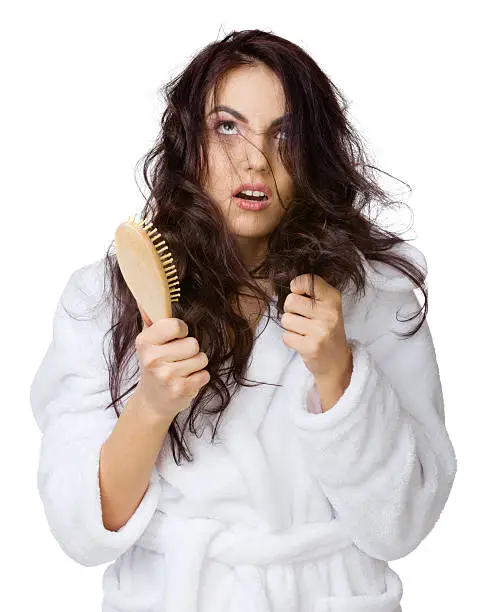 Displeased girl with haircomb isolated