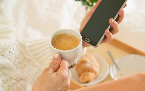 istock Woman eating breakfast in bed 470205380