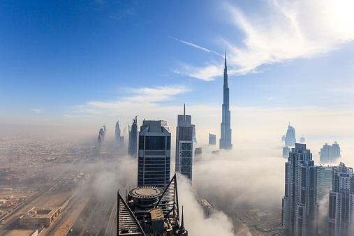 Early morning fog is covering Dubai business bay area.