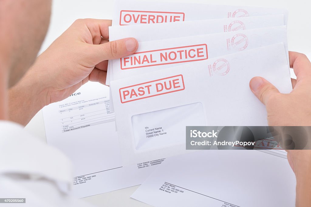 Man Holding Legal Notices Close-up Of A Man Holding Pending Due Statements Close To Stock Photo