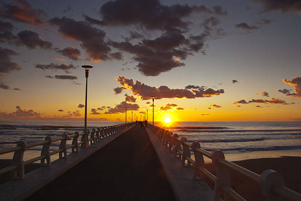 istock Forte dei marmi's pier at sunset with some people walking 470205770