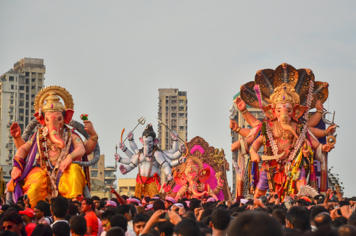 Mumbai, India - September 17, 2013: Devotees bringing Hindu God Ganesha into the ocean during Ganesha Festival