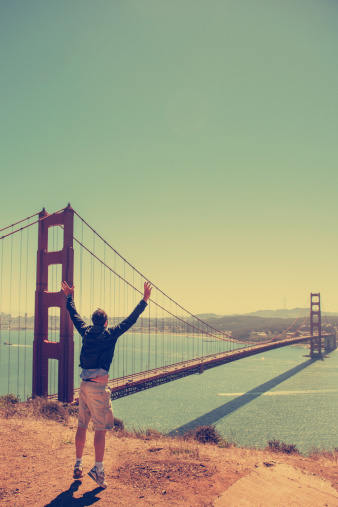 Man jumping against the San Francisco golden gate bridge