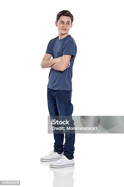 Happy Young Boy Looking Over Shoulder Stock Photo - Download Image Now - Boys, Teenage Boys, Teenager