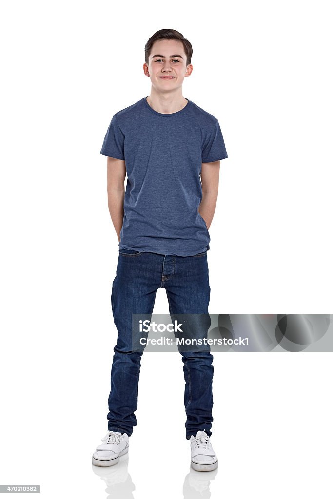 Cute young boy looking at camera smiling Full length portrait of cute young boy looking at camera smiling on white background Teenage Boys Stock Photo