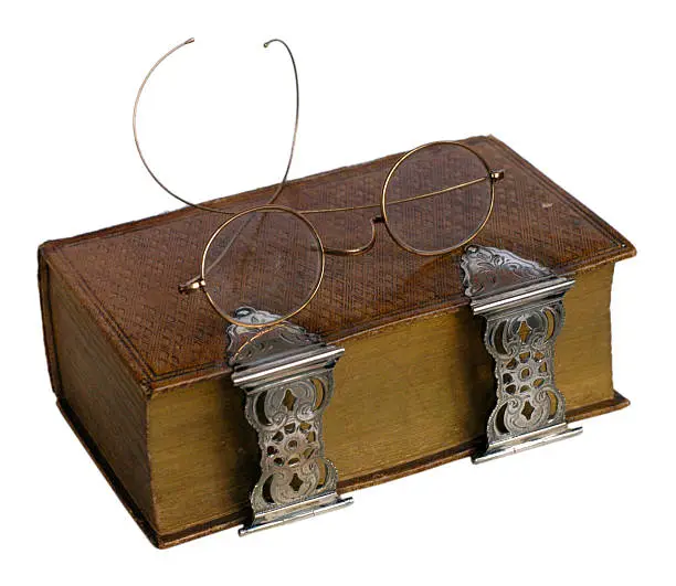 antique book with glasses