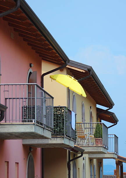 istock Yellow parasol on balcony with colorful house 470212901