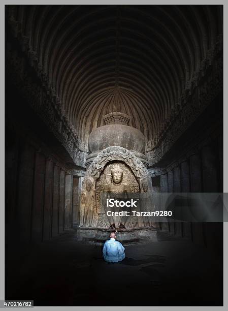 Monk Sitting In Front Of Buddha Statue Ellora Caves India Stock Photo - Download Image Now