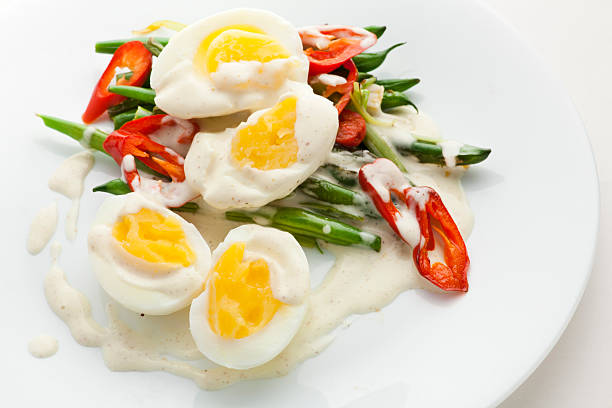 Asian Vegetable Salad with Boiled Eggs and white sauce stock photo