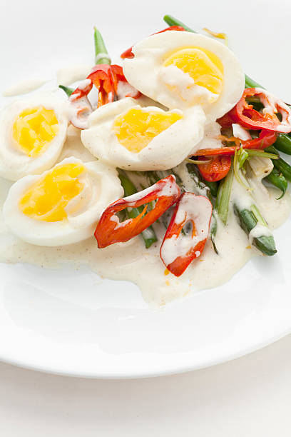 Asian Vegetable Salad with Boiled Eggs and white sauce stock photo
