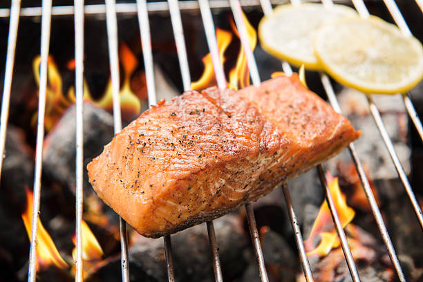 istock Grilled salmon with lemon on the flaming 470220842