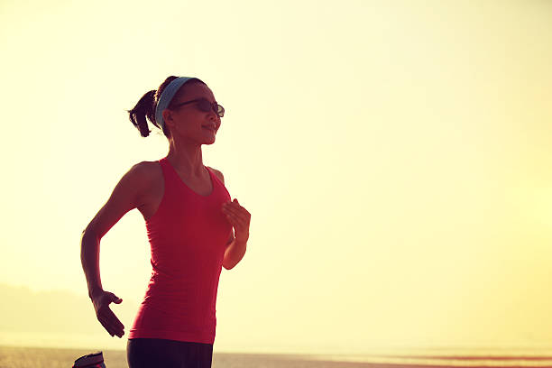 istock young  woman running on  beach 470221396
