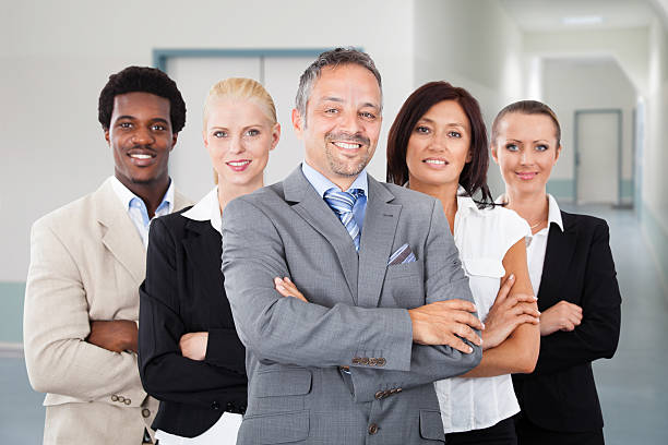 istock Confident Manager Standing Arms Crossed With Team 470221952