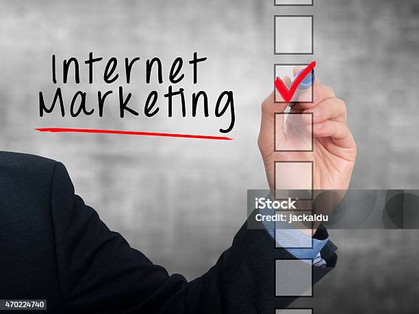 Businessman Hand Writing Internet Marketing And Check Listing Task Stock Photo - Download Image Now