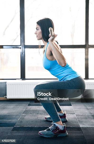 Young Woman Doing Squats With Barbell Stock Photo - Download Image Now - 2015, Adult, Anaerobic Exercise
