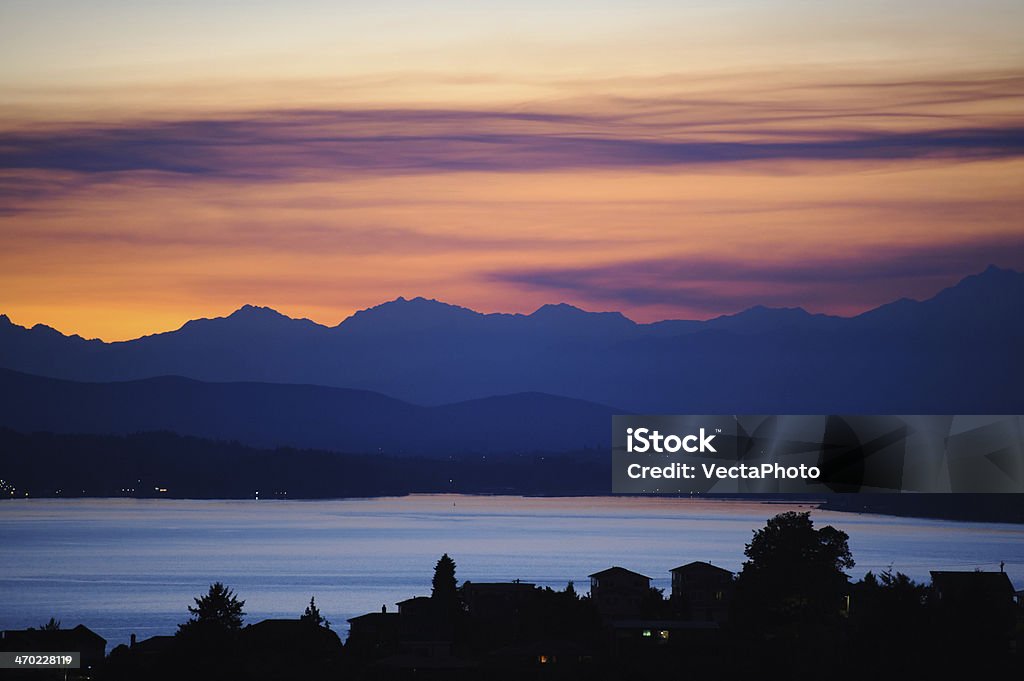 Puget Sound and Olympic Mountains Sunset behind Olympic Mountains and Puget Sound seen from Seattle in Washington State Cloud - Sky Stock Photo